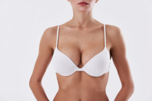 Close up of woman's breasts in white bra after natural-looking breast augmentation in Los Altos
